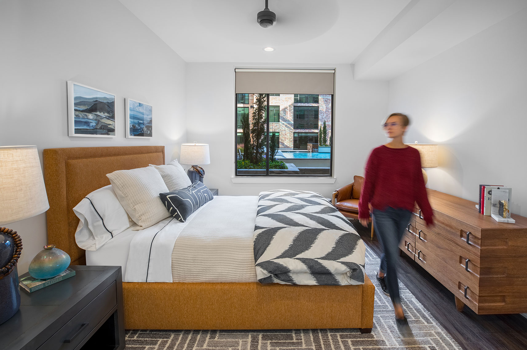 woman walking in her Bedroom at the St Andrie by Houston Interiors Photographer Shannon O