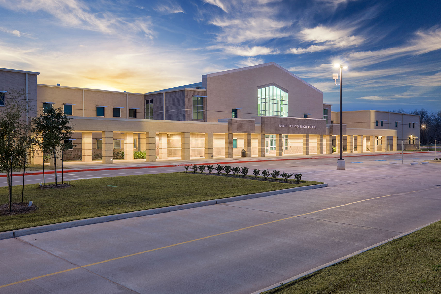 A school with sunrise behind it by Education Photographer