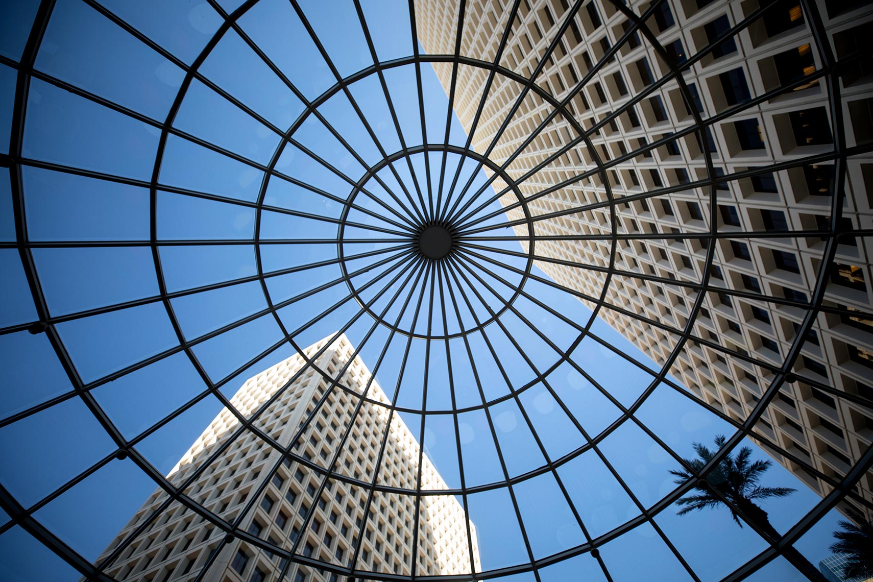 a view of office buildings through large circular skylight at Greenway Plaza in Houston by Architectural photographer