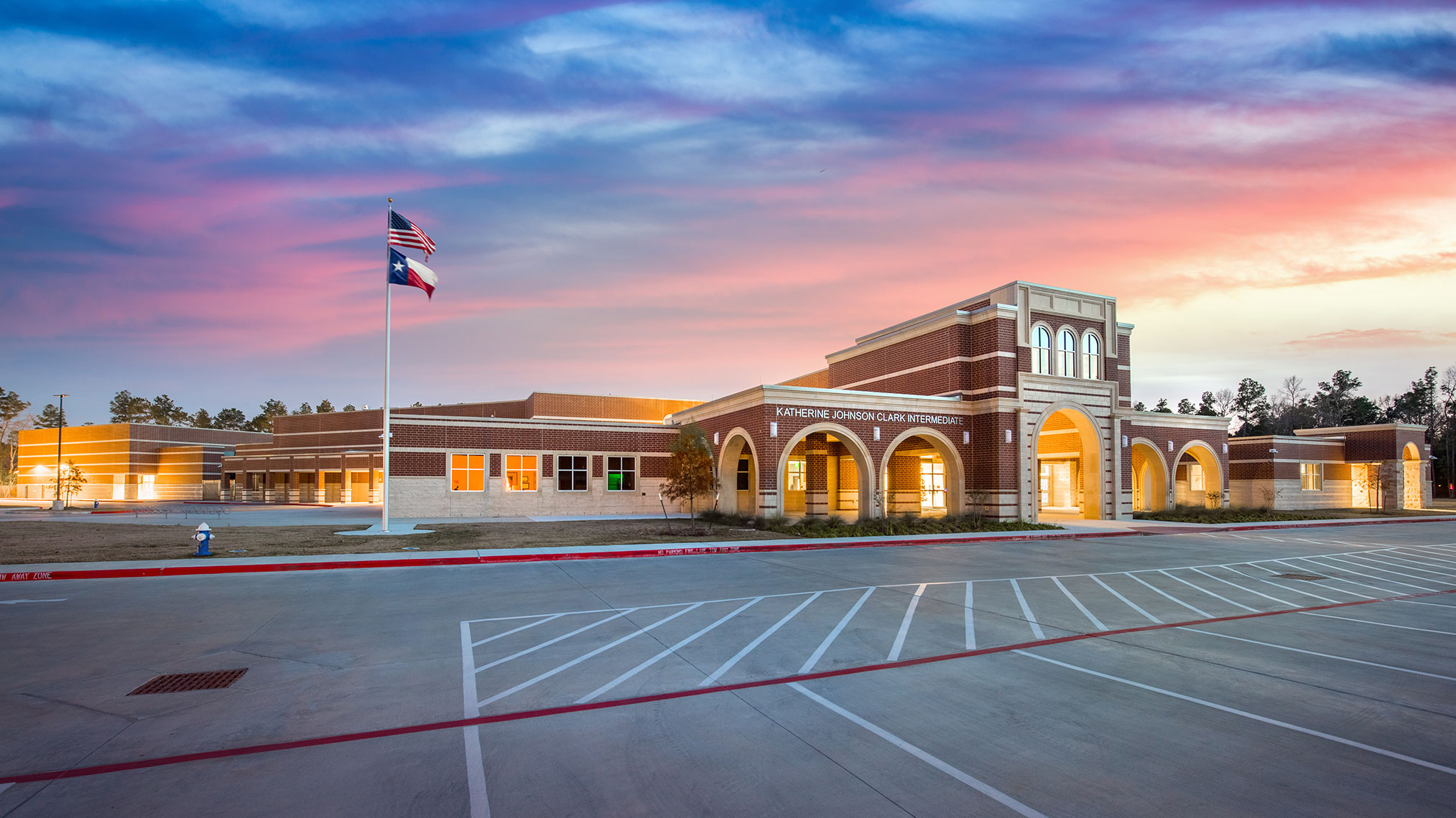 a school at sunset with Texas and American Flags by the best education architecture Photography