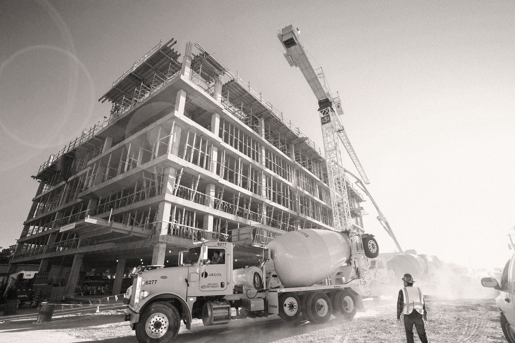 a dramatic black and white photo of concrete being poured at a construction site by A commercial photographer in Houston