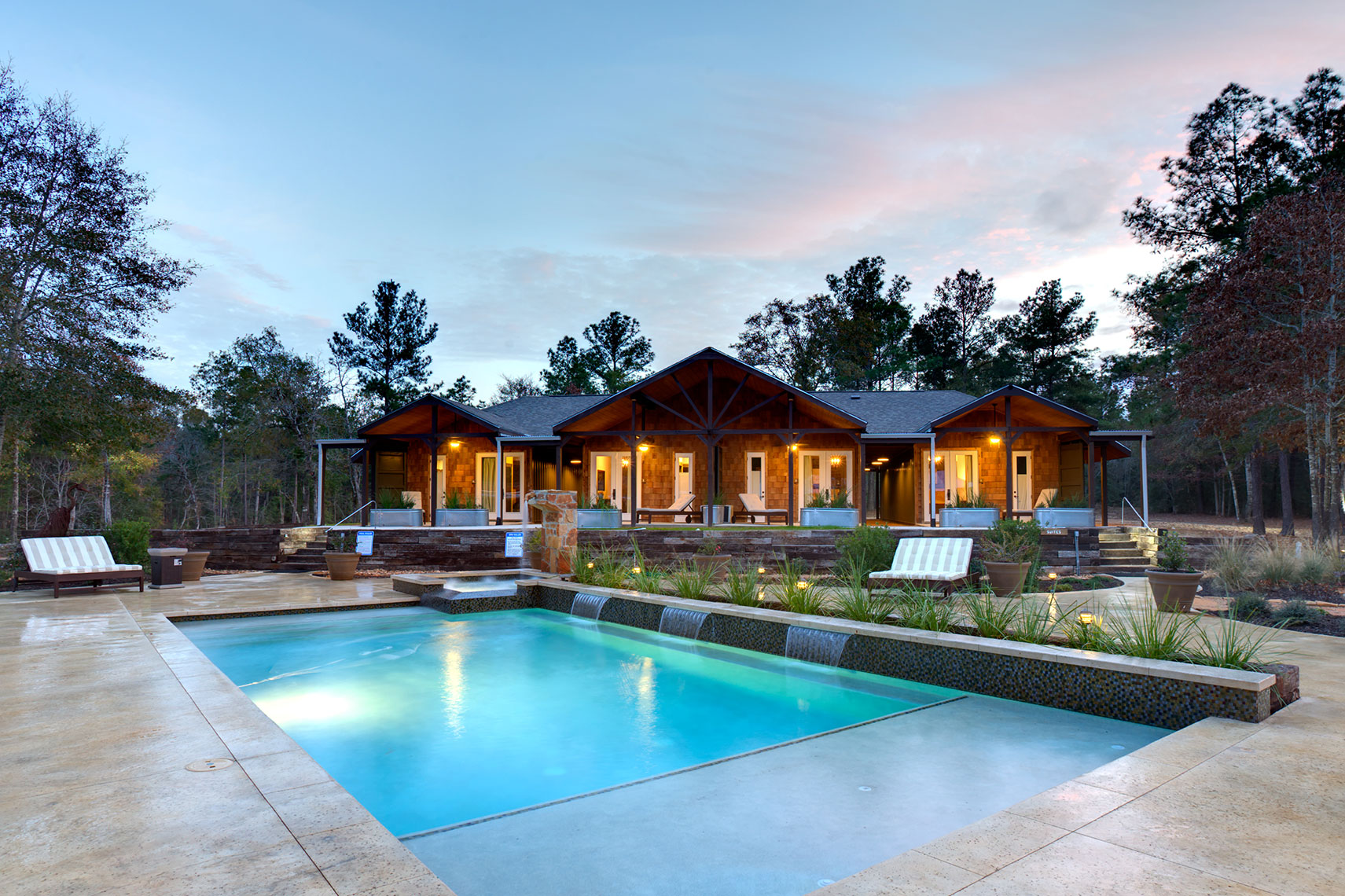a view at dusk of a boutique Hotel and resort pool by Hospitality Photographer