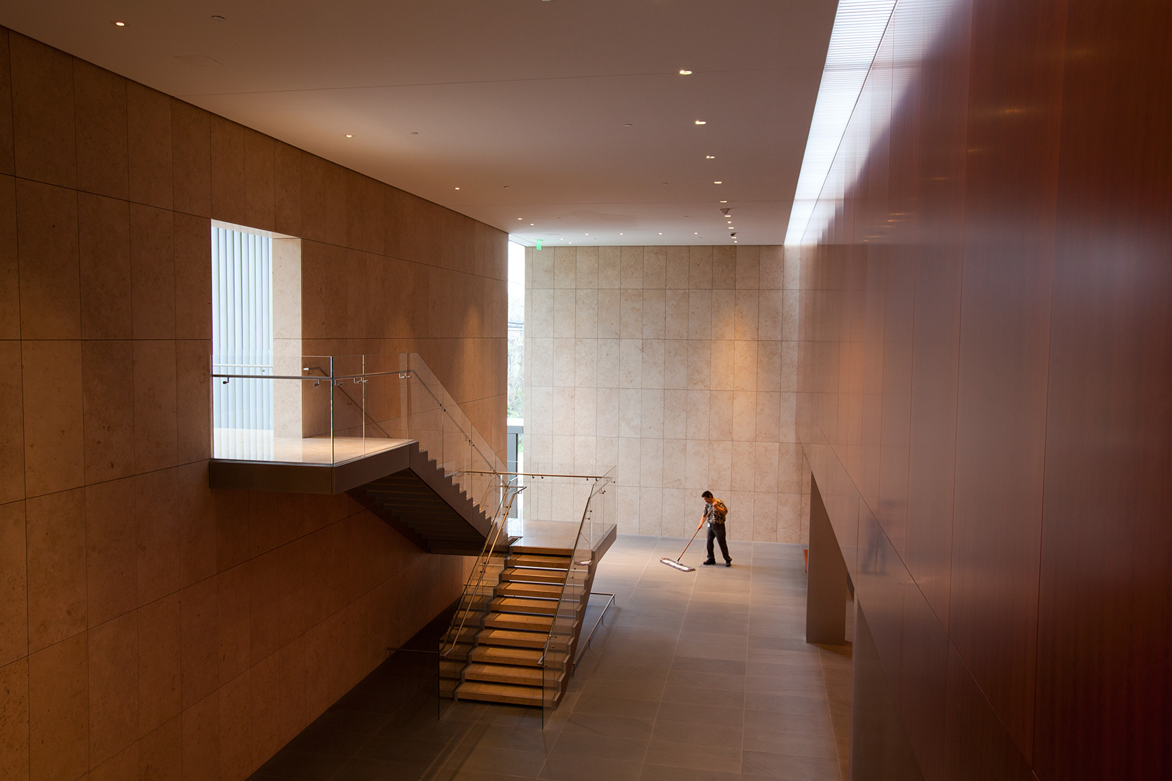 an architectural Photo of a custodian cleaning the floors of the Asia Society Museum in Houston Texas 